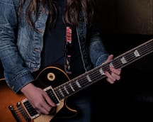 woman_in_blue_denim_jacket_holding_brown_acoustic_guitar-scopio-d021afcf-091c-48b7-a741-7f141edfd34b-min