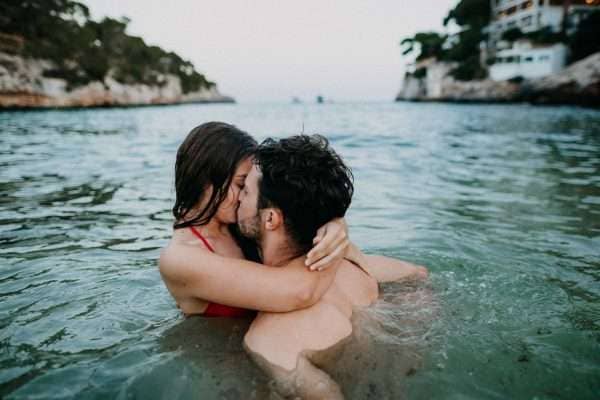 couple swimming and kissing