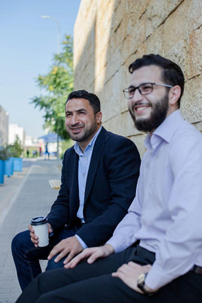 two_men_in_suits_sitting_outside_and_having_a_business_meeting-scopio-35c05921-f723-4556-9962-e4056ac21efc-min two business men