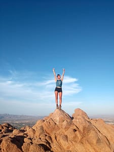 sportswoman on top of a mountain