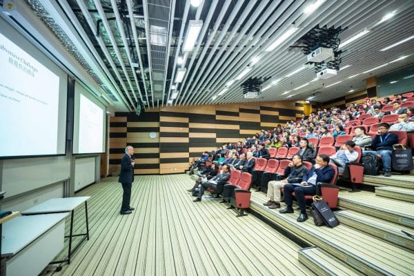 man-standing-in-front-of-people-sitting-on-red-chairs-1708936-min giving presentations man-standing-in-front-of-people-sitting-on-red-chairs-